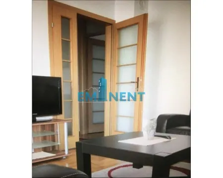View of part of the living room with furniture and wooden doors. - image 3
