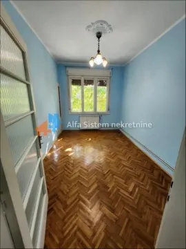 Empty room with parquet flooring and a window. - image 3