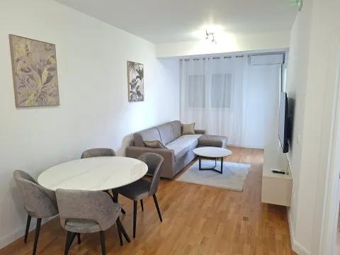 Living room with dining area, sofa and TV. - image 2