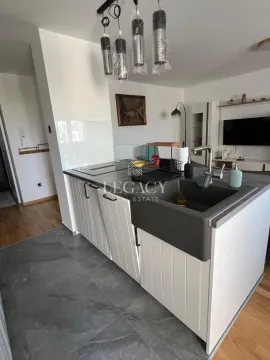 Kitchen with white cabinets, dark countertop, and sink. - image 4