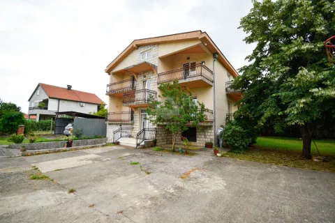 View of a multi-story house with a yard and balconies. - image 3