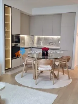 Modern kitchen with built-in units and a dining table in the middle. - image 4