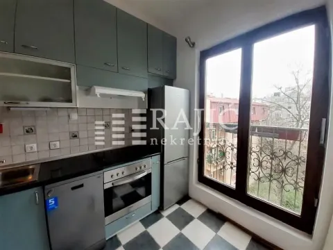Small kitchen with cabinets, refrigerator, and balcony access. - image 6
