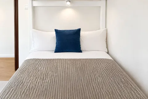 Tidy bedroom with a double bed and white bedding. - image 13