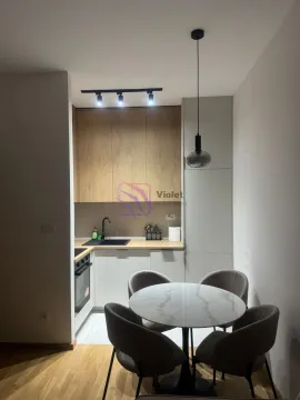 Smaller kitchen with a dining table and four chairs. - image 3