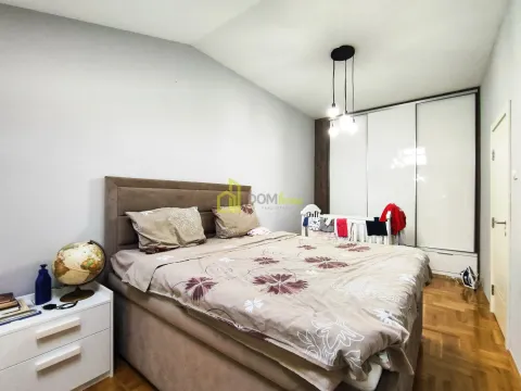 Spacious bedroom with a double bed, wardrobe, and baby crib. - image 8