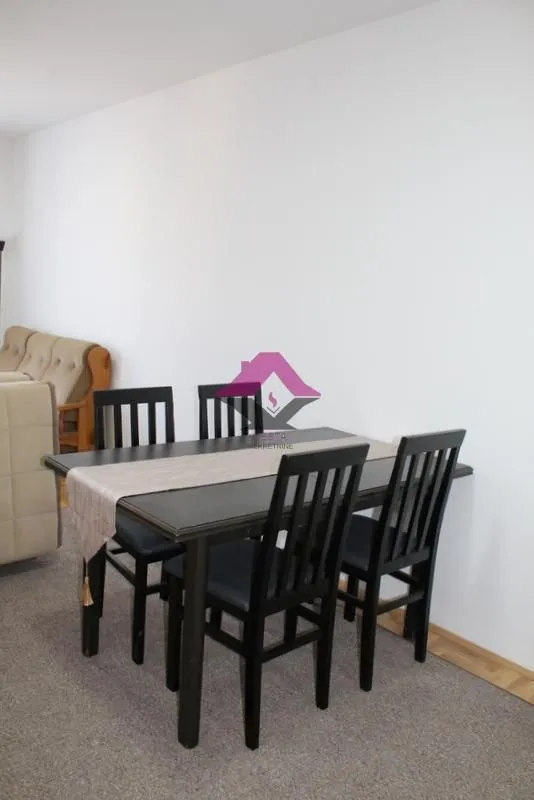 Dining table with black chairs in the living room.