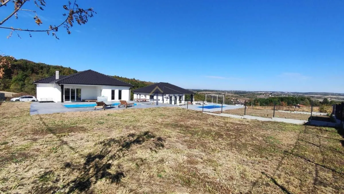Exterior of the house with a swimming pool and a large yard.