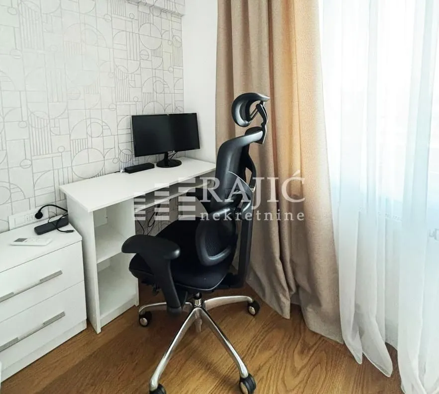 Study room with a desk and chair by the window.