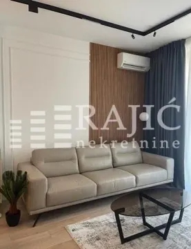 Modern living room with a sofa and a decorative wooden wall panel. - image 3