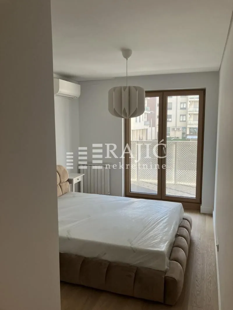 Bedroom with a double bed and balcony access.
