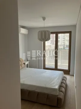 Bedroom with a double bed and balcony access. - image 5