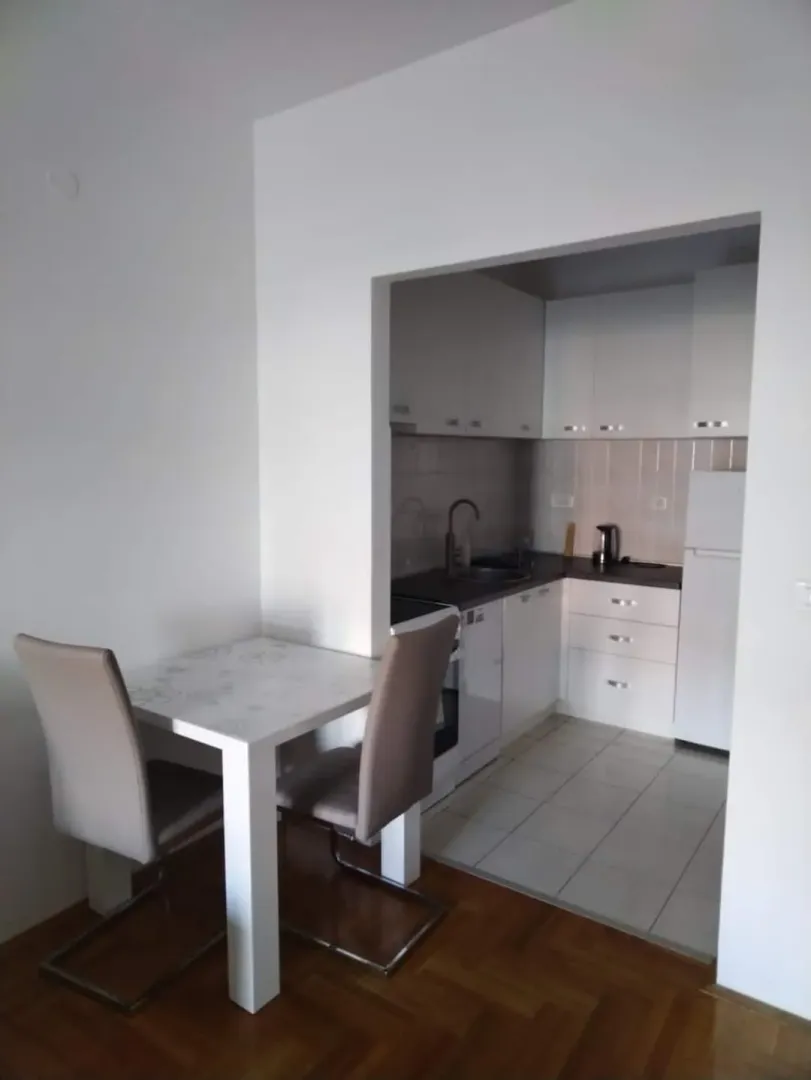 Small kitchen with a dining table and chairs.