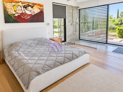 Modern bedroom with a double bed and a glass partition leading to the bathroom. - image 17