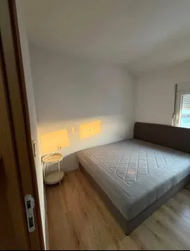 Bedroom with a double bed and a small side table. - image 5