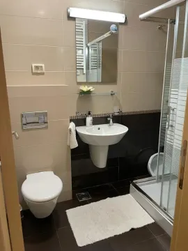 A bright and modern bathroom with a shower cabin and mirror. - image 6