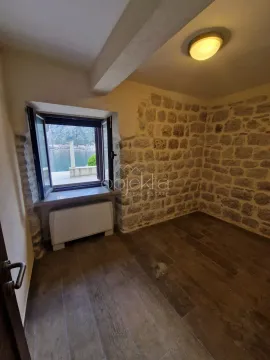 Empty room with a stone wall and a window with a sea view. - image 7