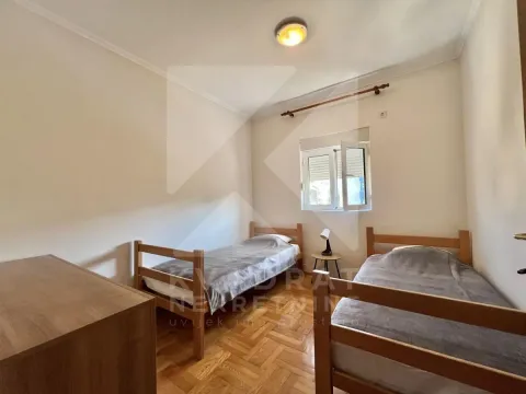 Bedroom with two wooden beds and parquet flooring. - image 7