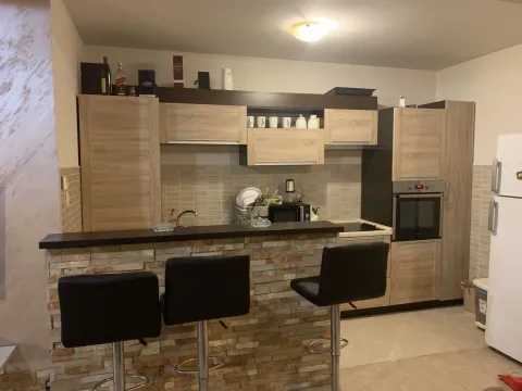 Kitchen with a bar counter and three bar stools. - image 5