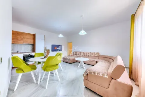 Spacious living room with a sectional sofa, dining area, and a kitchen section. - image 4