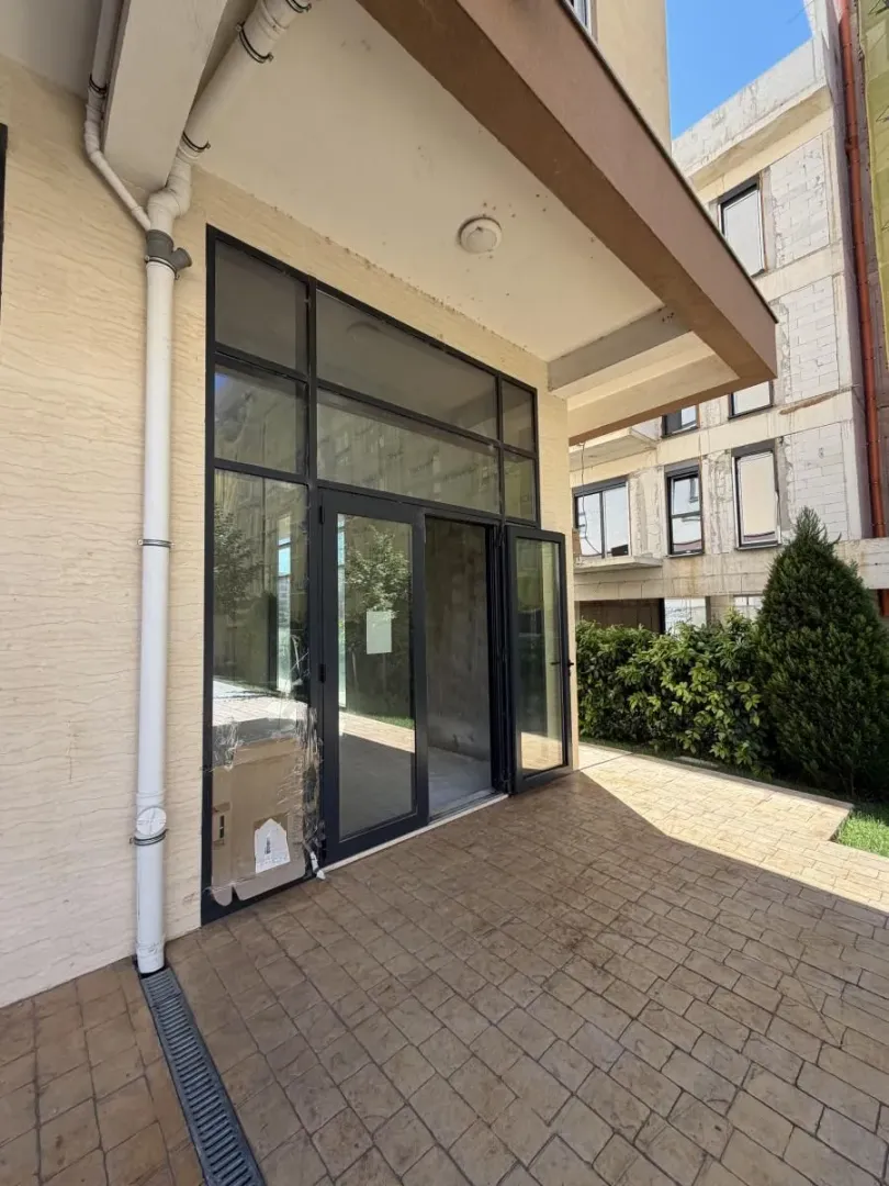 Entrance to a commercial space with glass doors and storefront.