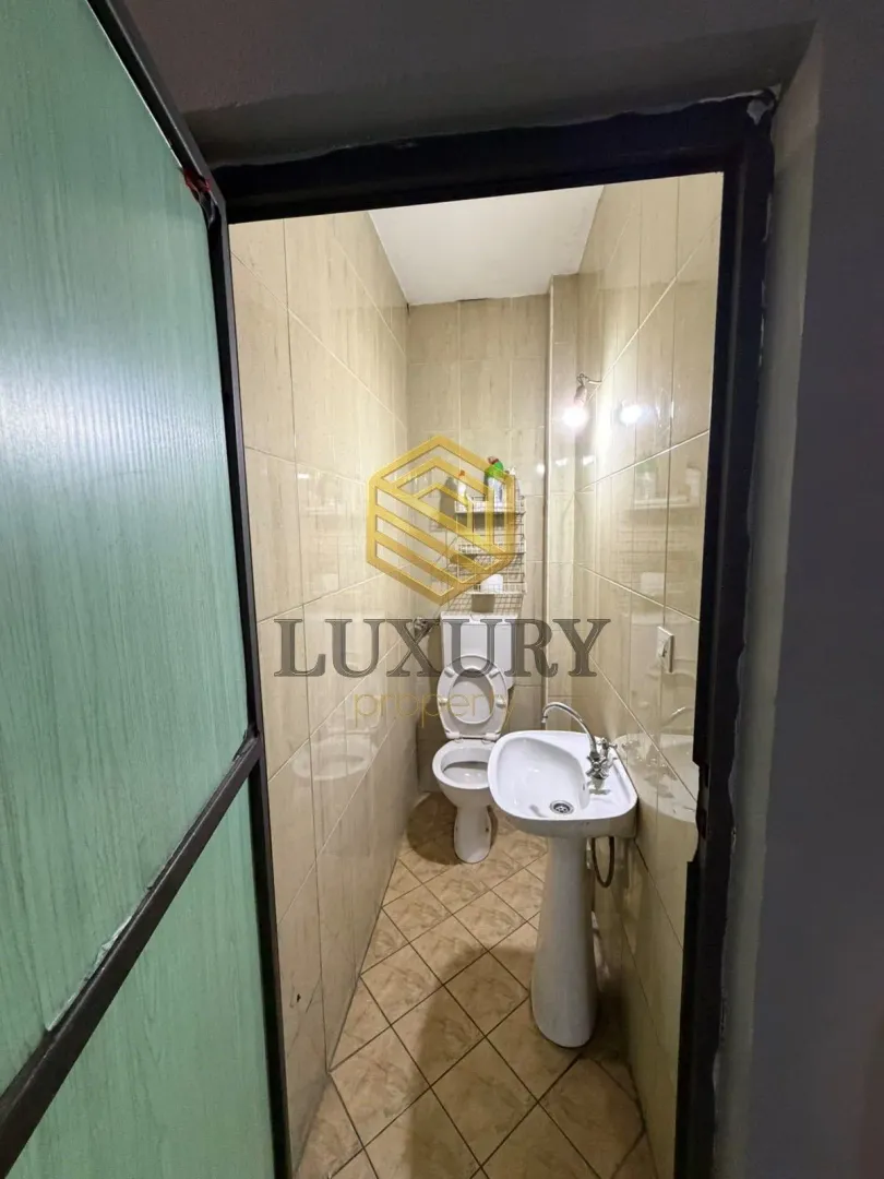 Small bathroom with a sink and toilet.