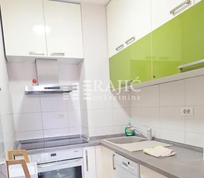 Smaller kitchen with white and green cabinets. - image 8