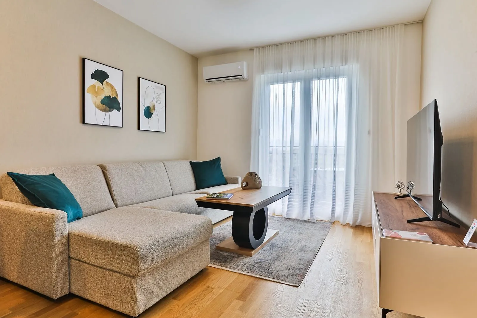 Furnished living room with a sofa, coffee table, and television.