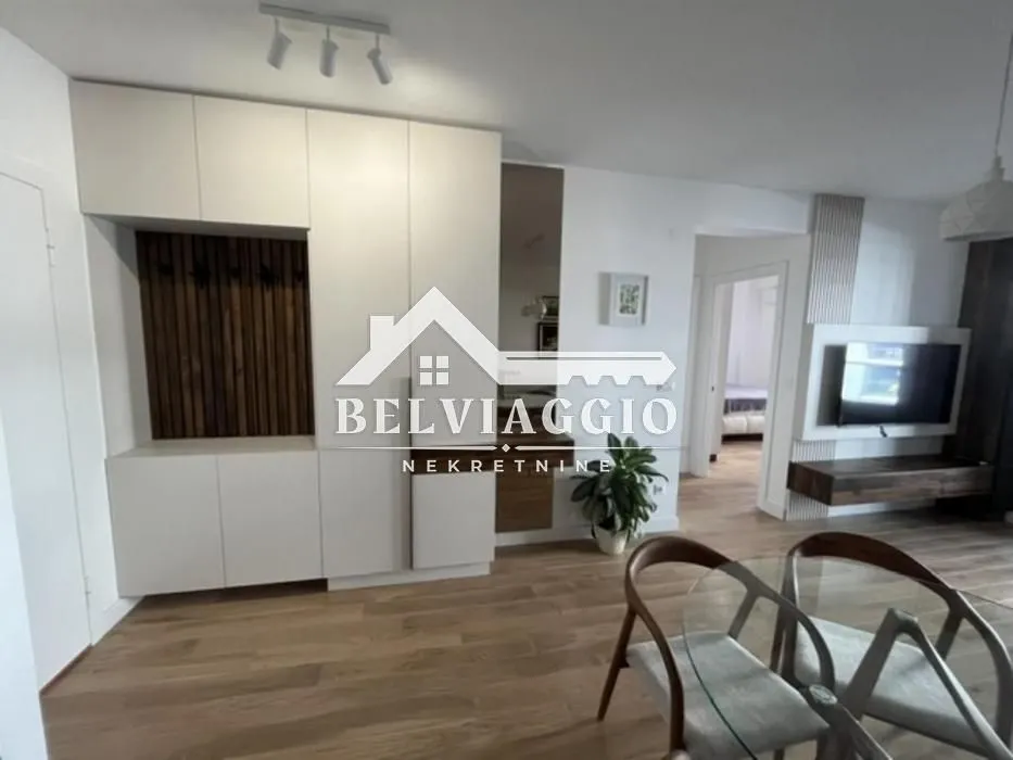 Living room with dining area and built-in wardrobes.