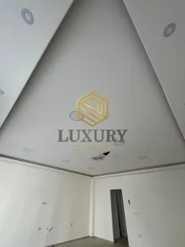 View of the high ceiling and white walls in an empty room. - image 6