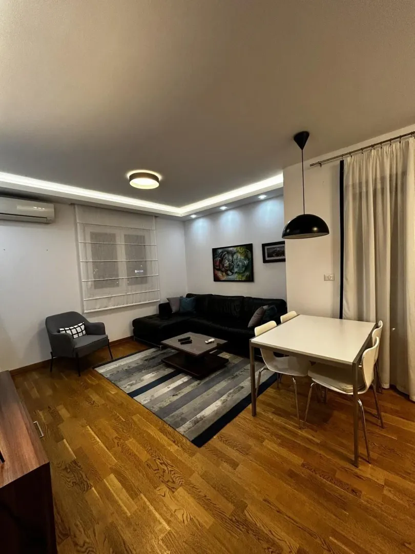 Living room with a corner sofa, coffee table, and dining table.