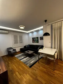 Living room with a corner sofa, coffee table, and dining table. - image 3