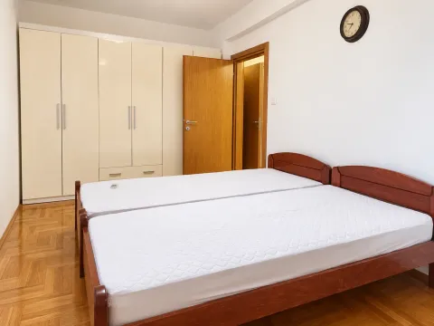 Furnished bedroom with a large double bed and a fitted wardrobe. - image 6