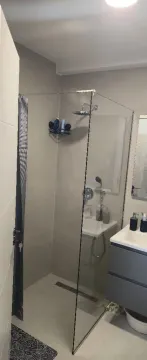 Modernly equipped bathroom with a walk-in shower and vanity unit. - image 7