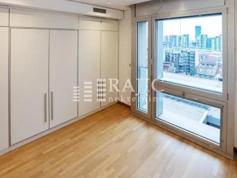 Bright bedroom with built-in wardrobes and city views. - image 6