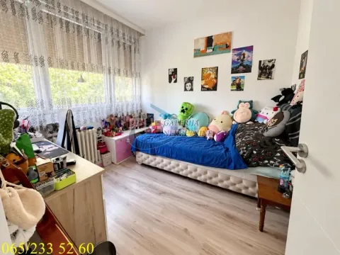 Children's bedroom with a bed, desk, and decorative pictures on the wall. - image 7