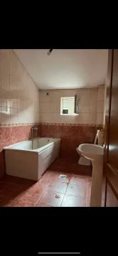 Bathroom tiled in ceramics with a bathtub, washbasin, and toilet. - image 11