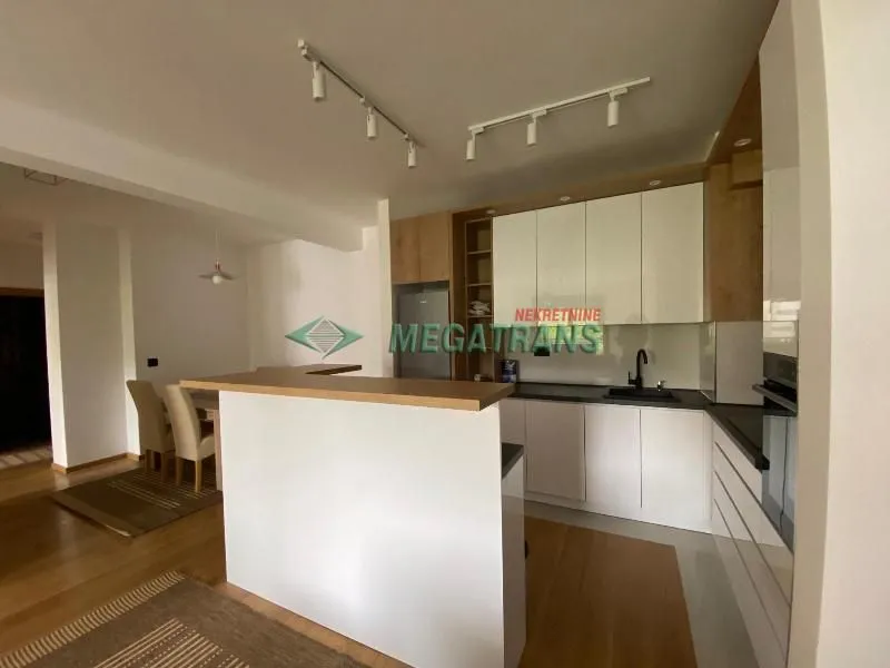 Modern kitchen with a breakfast bar and built-in appliances.