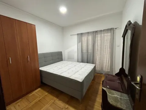 Namještena spavaća soba sa bračnim krevetom, drvenim ormarom i komodom sa ogledalom. - image 4
