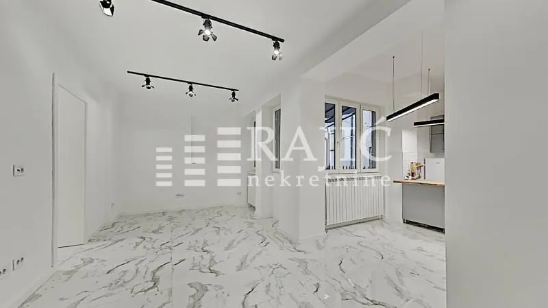 Bright living room with marble tiles and modern lighting.