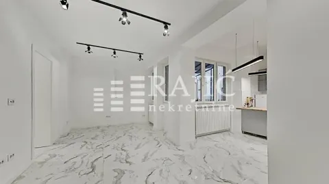 Bright living room with marble tiles and modern lighting. - image 2