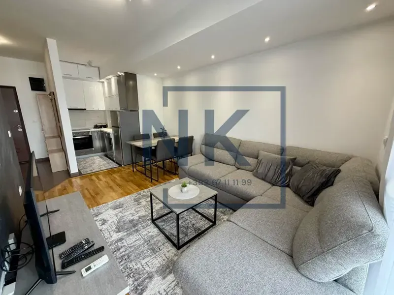 Living room with sofa and dining area.