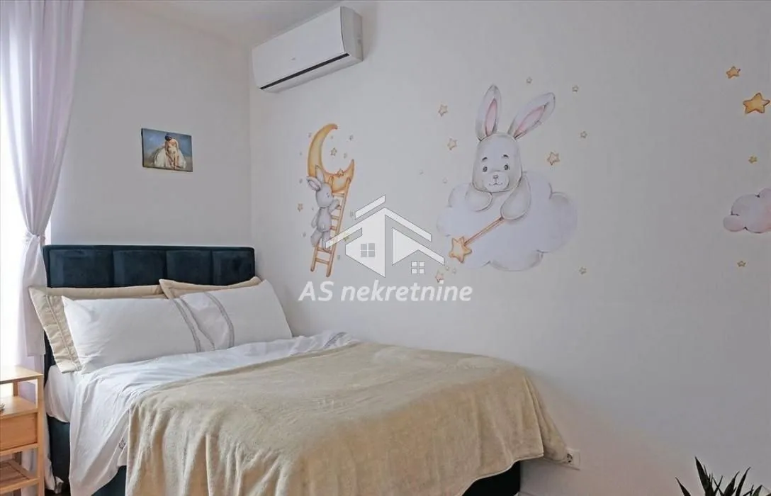 Children's bedroom with a double bed and wall stickers.