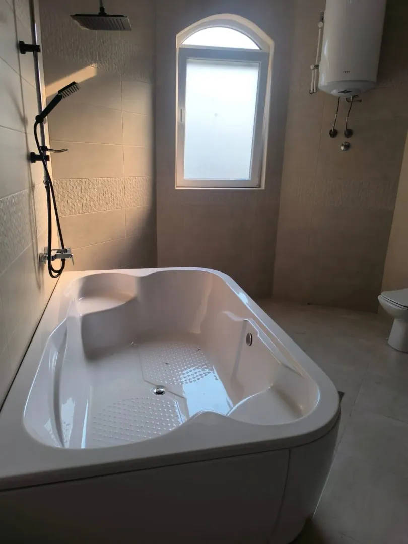Modern bathroom with a bathtub and shower.