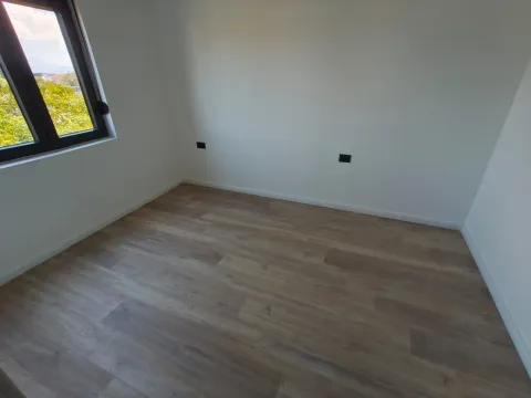 Empty room with white walls, wooden floor, and a window. - image 5