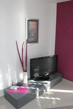Living room with a TV and chest of drawers. - image 3
