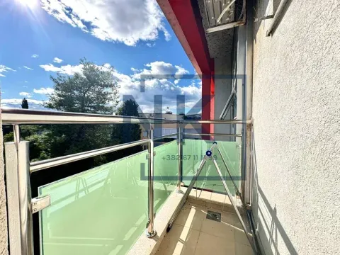 Balcony with a glass railing and a view of the surroundings. - image 6