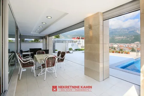 Large covered terrace with a dining table, seating furniture, and a view of the pool and surroundings. - image 5
