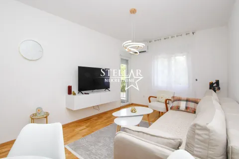Bright and furnished living room with a TV and sofa set. - image 3