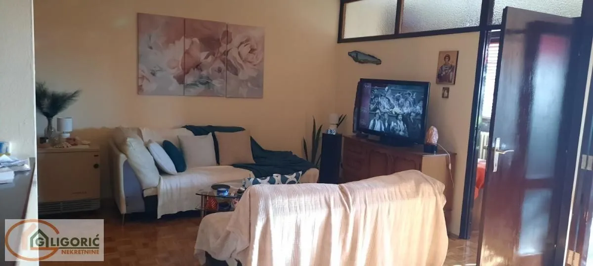Dnevna soba sa garniturom i televizorom.